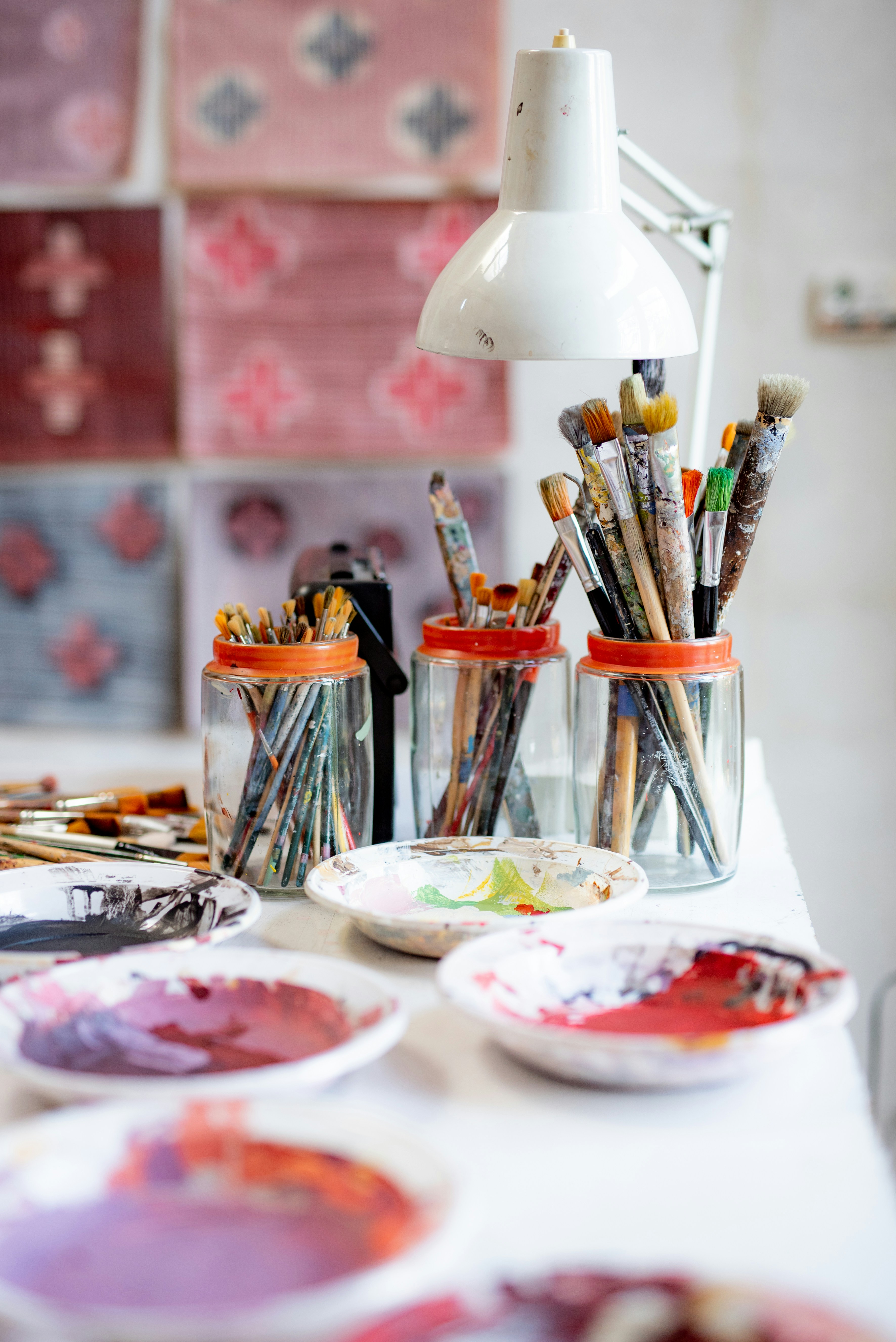 Creative workspace with paint brushes and colorful artwork